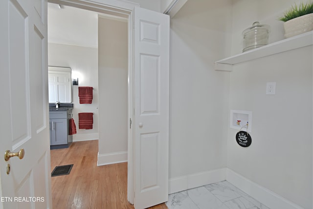 clothes washing area with laundry area, baseboards, visible vents, hookup for a washing machine, and marble finish floor