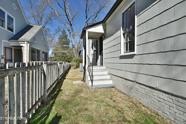 view of side of home with fence