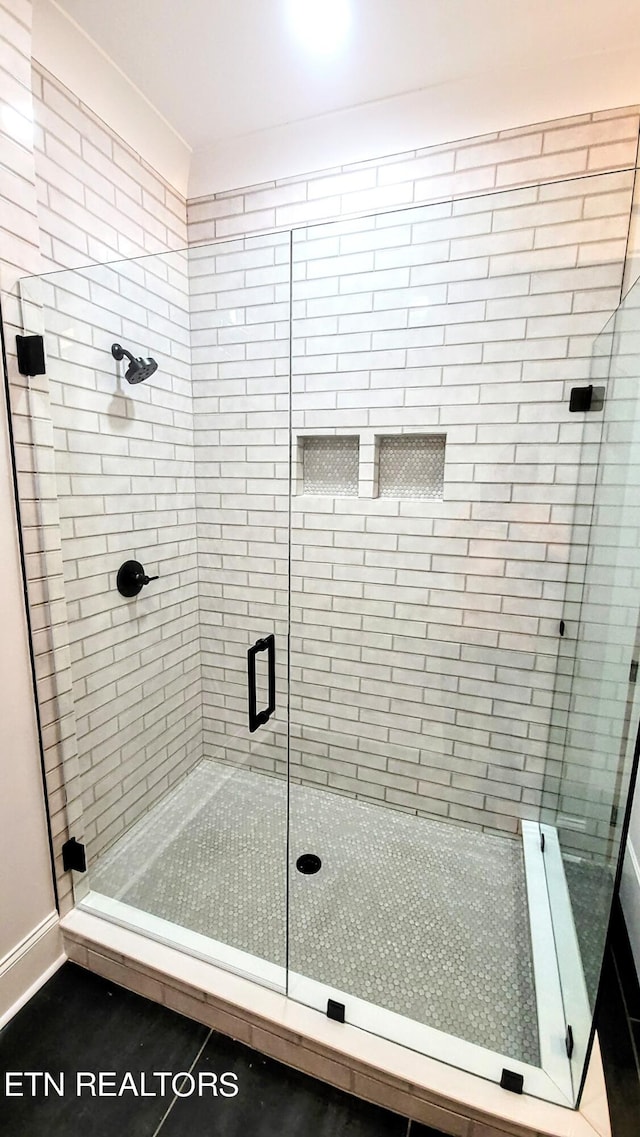 bathroom featuring a shower stall