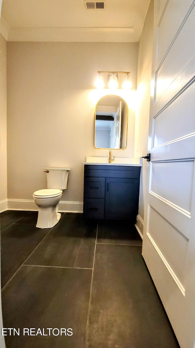 half bath featuring toilet, visible vents, vanity, baseboards, and crown molding