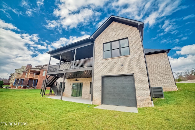 back of house with a ceiling fan, a yard, brick siding, and a patio