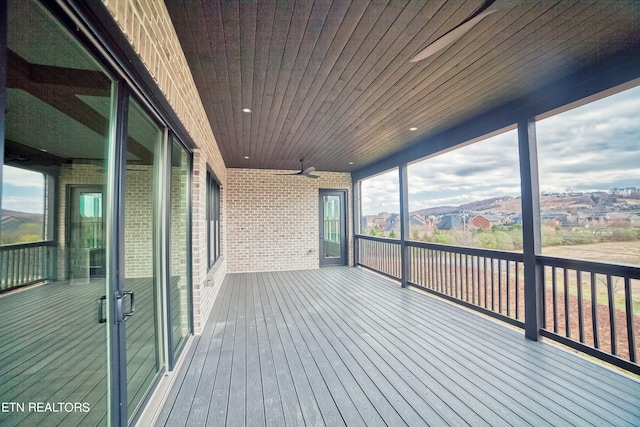 wooden deck featuring ceiling fan