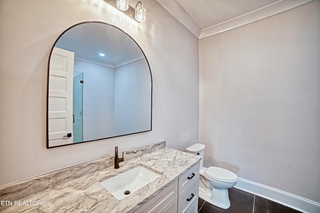 bathroom with vanity, tile patterned floors, toilet, and crown molding