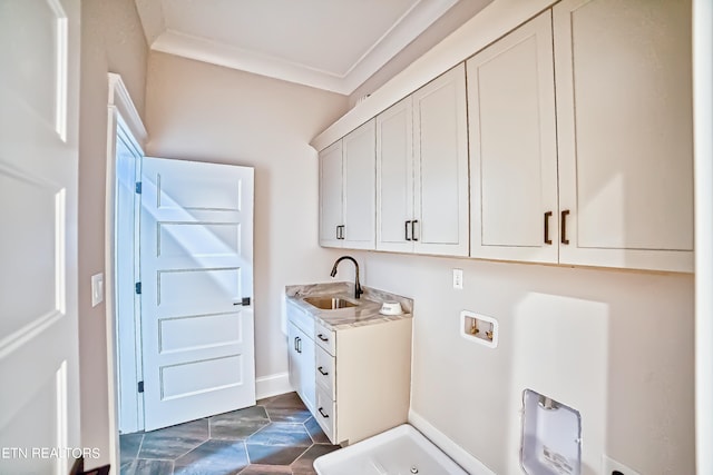 washroom with washer hookup, a sink, baseboards, ornamental molding, and cabinet space