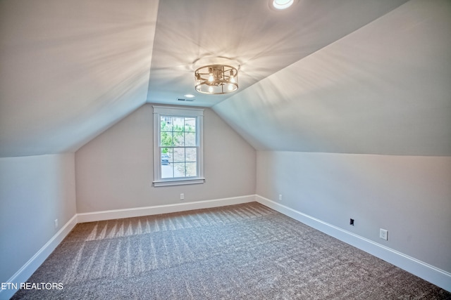 bonus room featuring lofted ceiling, carpet flooring, visible vents, and baseboards