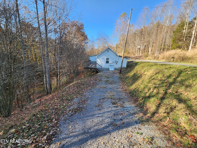 view of property exterior with a deck