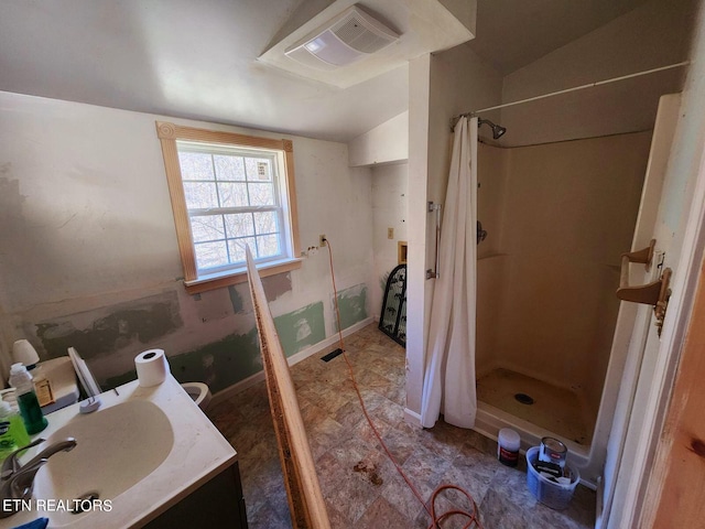 bathroom with vaulted ceiling, vanity, and a shower with curtain