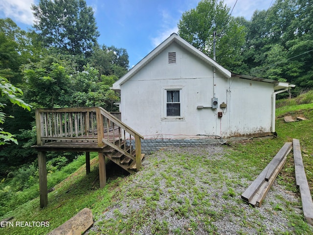 view of side of property with a wooden deck