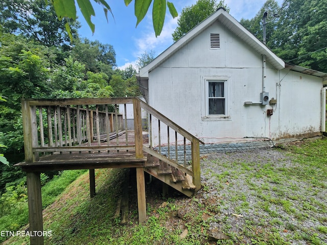 back of property with a deck