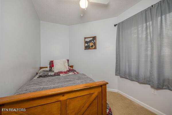 bedroom featuring light colored carpet and ceiling fan