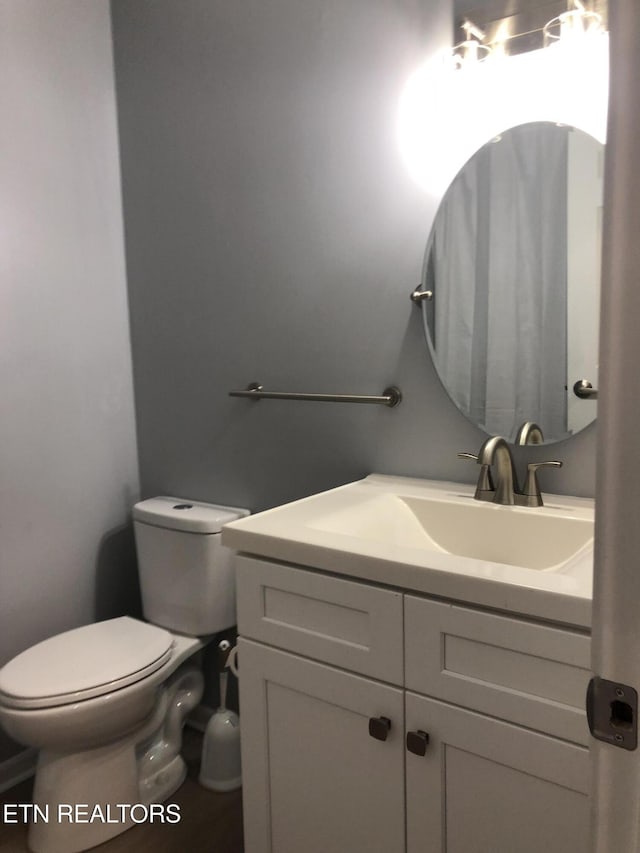 bathroom with vanity and toilet