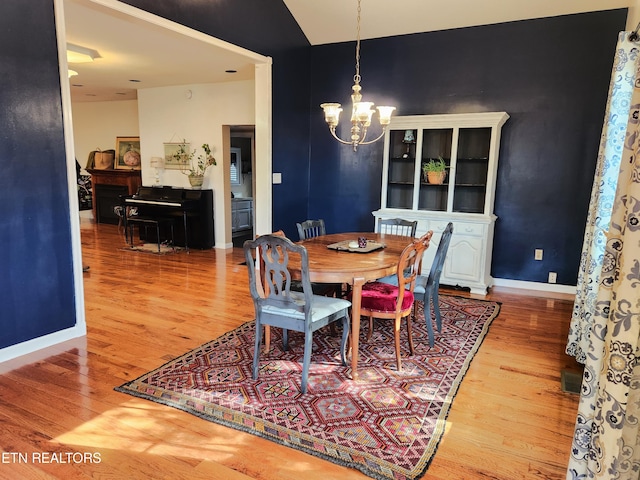 dining area featuring a chandelier and light hardwood / wood-style flooring