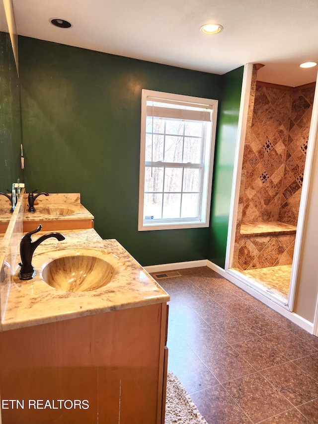 bathroom with dual bowl vanity and tile floors