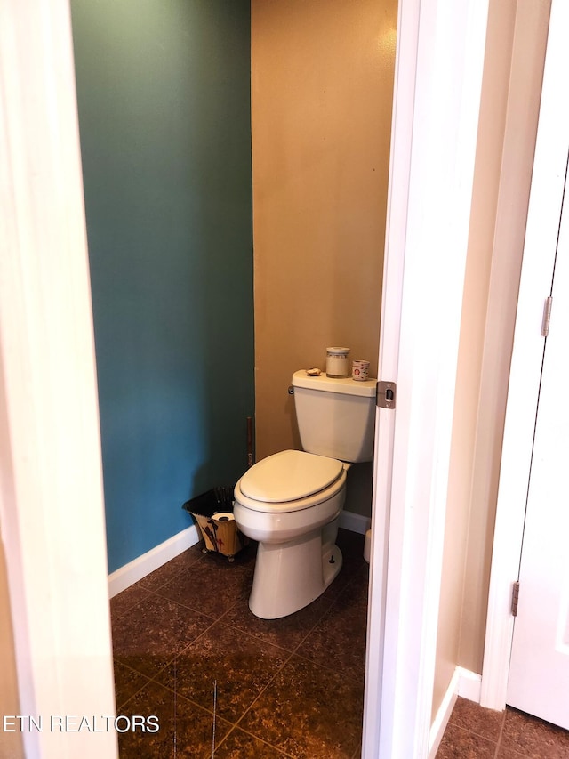 bathroom with tile flooring and toilet