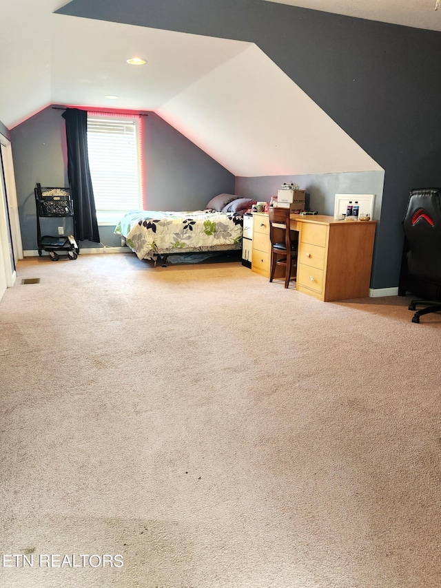 carpeted bedroom with lofted ceiling