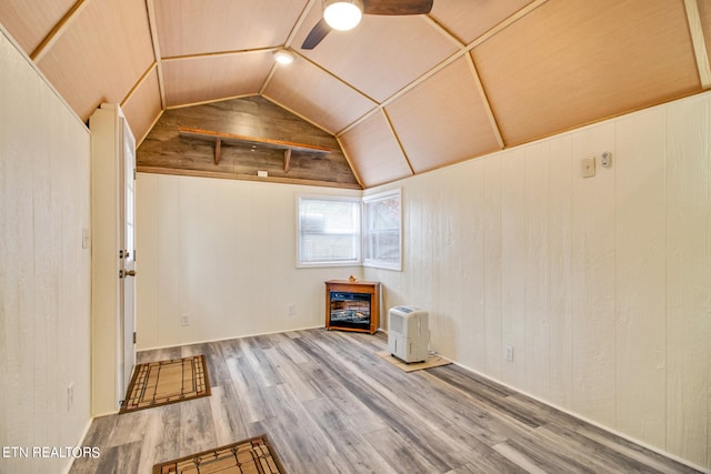 interior space featuring ceiling fan, vaulted ceiling, and wood-type flooring