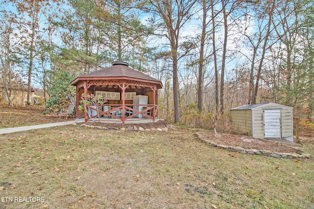 view of yard with a gazebo and a storage unit