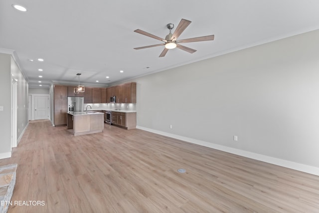 unfurnished living room with sink, ceiling fan, light hardwood / wood-style floors, and crown molding