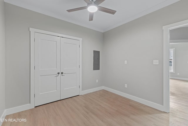 unfurnished bedroom with ornamental molding, a closet, ceiling fan, and light hardwood / wood-style flooring