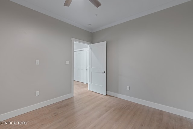 spare room featuring ceiling fan, light wood-type flooring, and ornamental molding