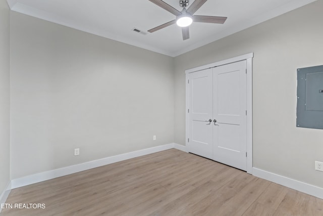 unfurnished bedroom with a closet, ceiling fan, light hardwood / wood-style flooring, and ornamental molding