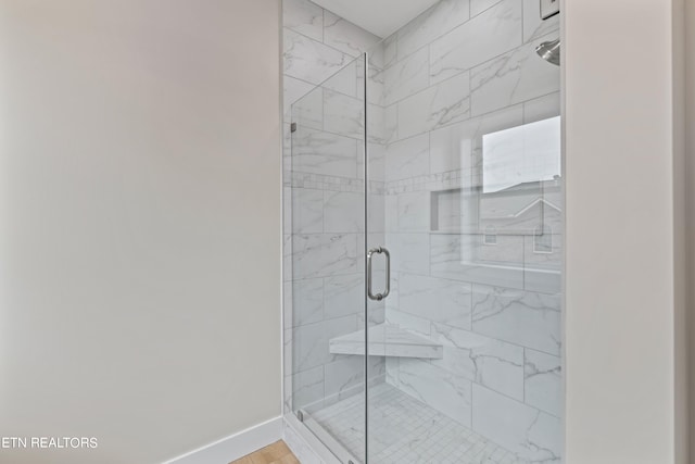 bathroom featuring a shower with shower door