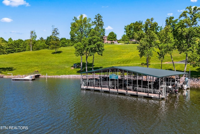 view of dock featuring a lawn and a water view