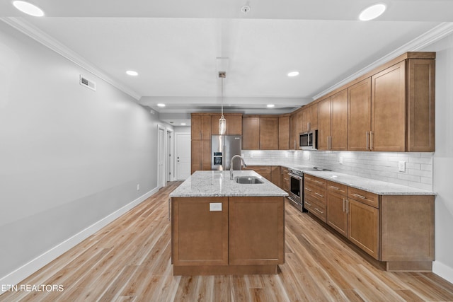 kitchen featuring sink, light wood-type flooring, ornamental molding, and appliances with stainless steel finishes