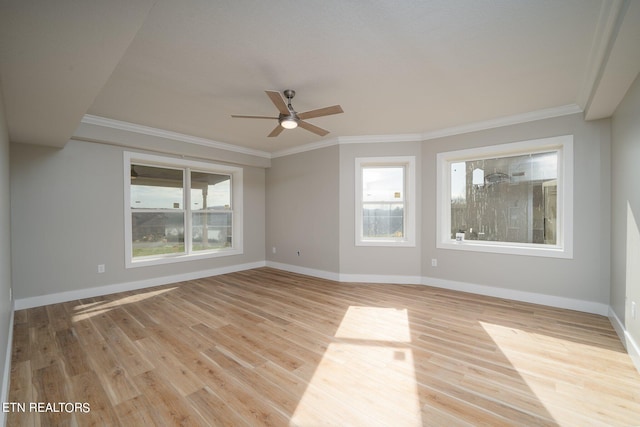 empty room with ceiling fan, ornamental molding, and light hardwood / wood-style flooring