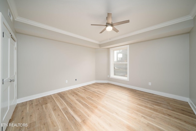 spare room with ornamental molding, ceiling fan, and light hardwood / wood-style flooring