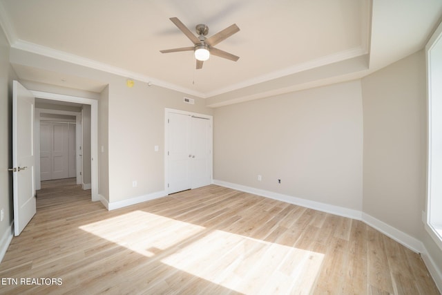 unfurnished bedroom with a closet, ceiling fan, light wood-type flooring, and ornamental molding