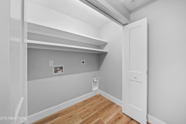 laundry area with light hardwood / wood-style floors, washer hookup, and hookup for an electric dryer