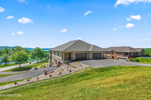 ranch-style house featuring a garage and a front lawn