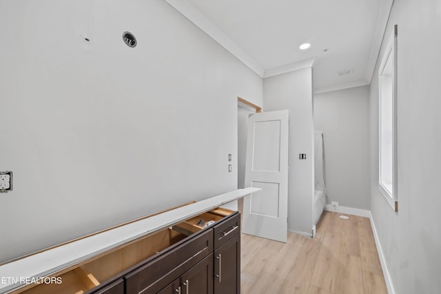 hallway featuring light hardwood / wood-style floors and crown molding