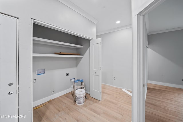 interior space featuring crown molding, hookup for a washing machine, light wood-type flooring, electric dryer hookup, and hookup for a gas dryer