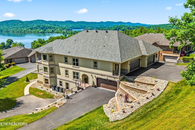 drone / aerial view featuring a water and mountain view