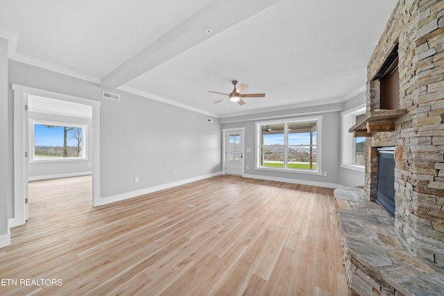 unfurnished living room with light hardwood / wood-style floors, ornamental molding, a fireplace, and ceiling fan