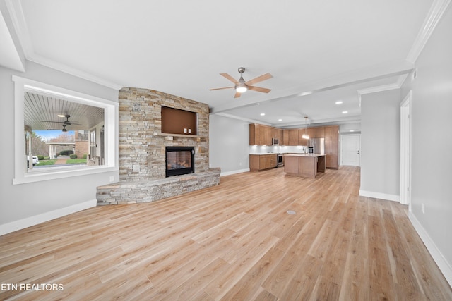 unfurnished living room featuring a stone fireplace, ceiling fan, light wood-type flooring, and crown molding