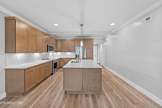 kitchen featuring an island with sink, ornamental molding, light hardwood / wood-style flooring, and stainless steel appliances