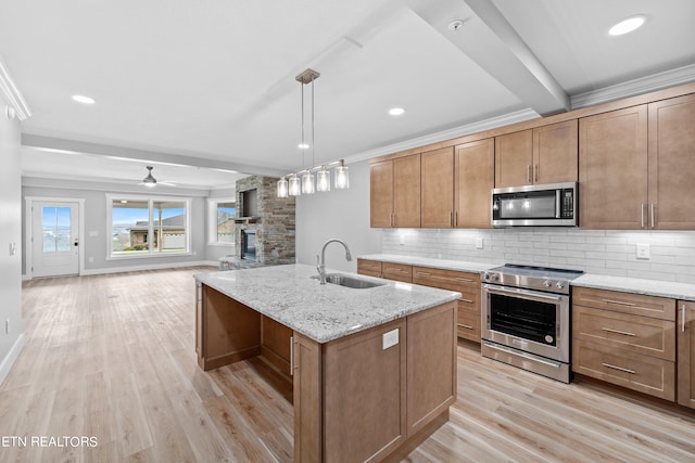 kitchen featuring sink, tasteful backsplash, light wood-type flooring, and stainless steel appliances