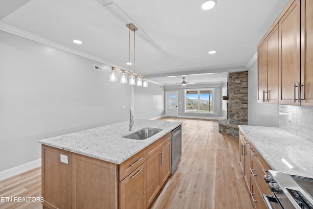 kitchen featuring light hardwood / wood-style flooring, hanging light fixtures, ceiling fan, tasteful backsplash, and sink