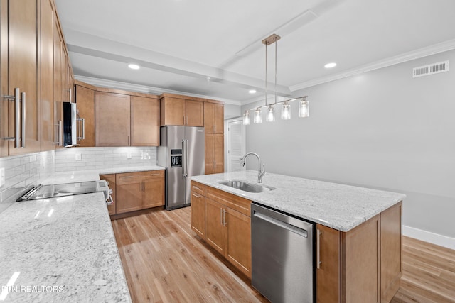 kitchen with light stone countertops, stainless steel appliances, light wood-type flooring, and sink