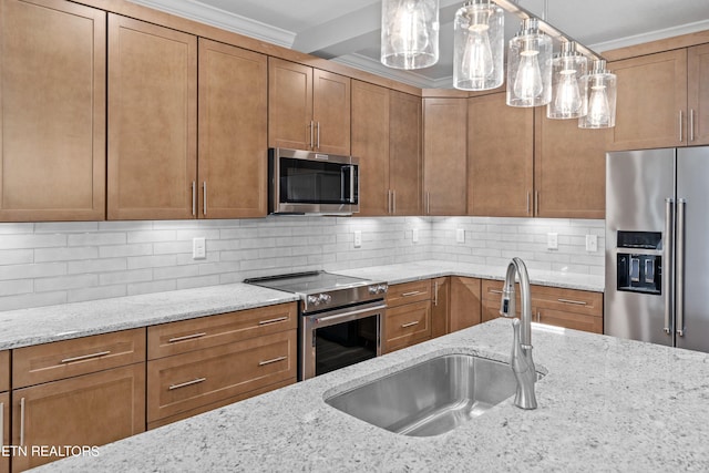 kitchen with light stone countertops, high end appliances, backsplash, pendant lighting, and sink