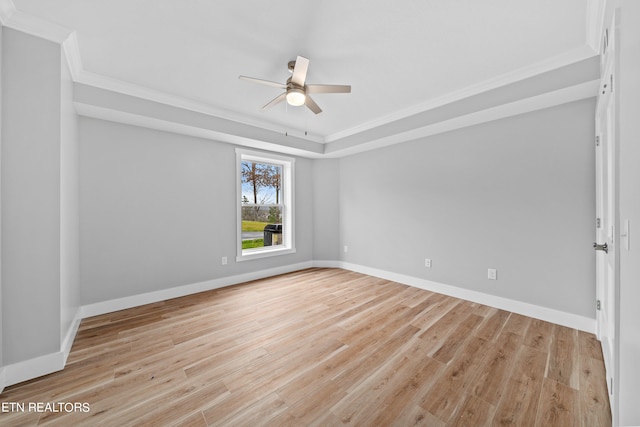 spare room featuring crown molding, light wood-type flooring, and ceiling fan