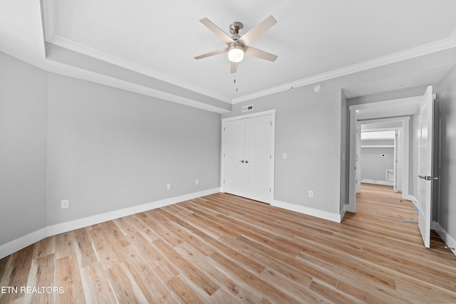 unfurnished bedroom featuring ornamental molding, ceiling fan, and light hardwood / wood-style flooring