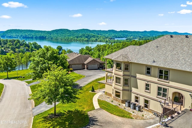 birds eye view of property with a water and mountain view