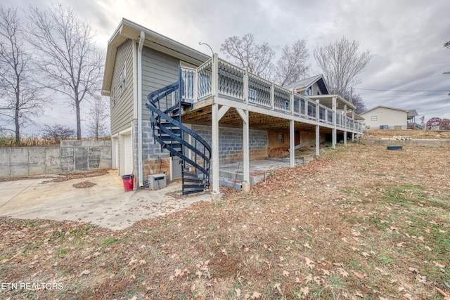 back of property featuring a deck and a patio area