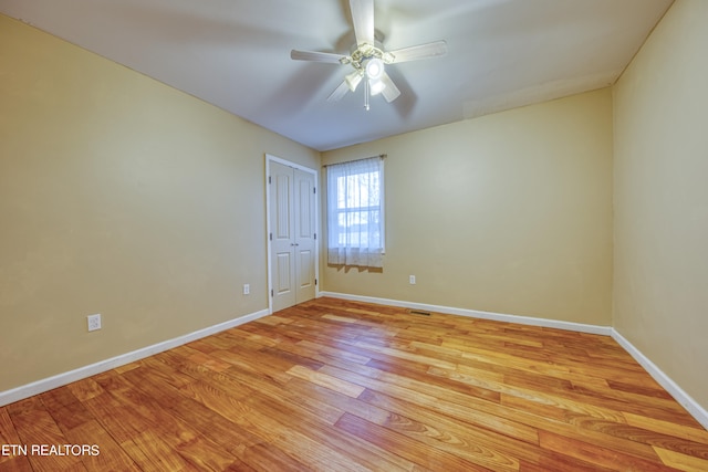 spare room with light hardwood / wood-style floors and ceiling fan