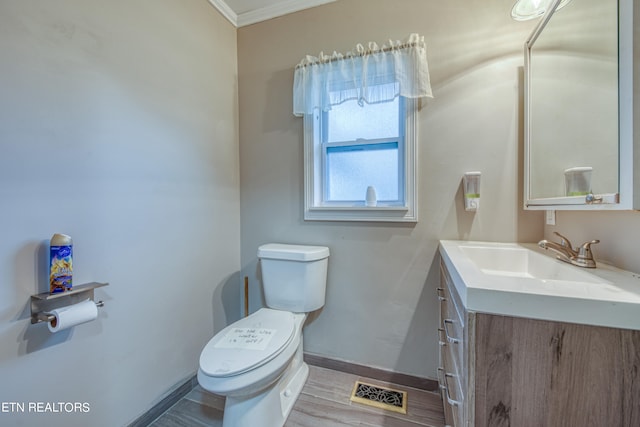 bathroom with crown molding, toilet, wood-type flooring, and large vanity