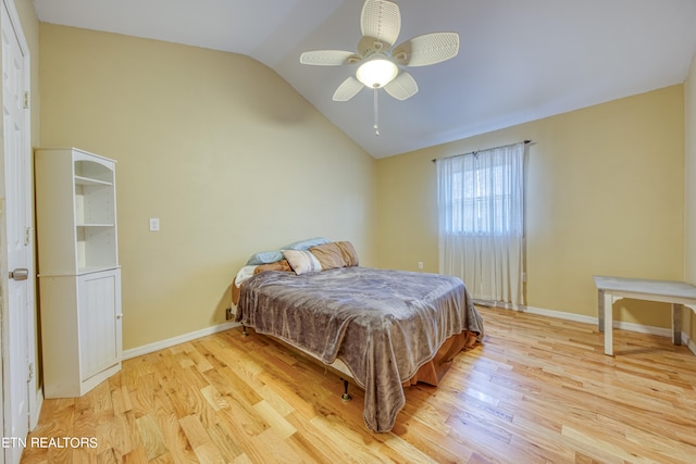 bedroom with light hardwood / wood-style floors, ceiling fan, and vaulted ceiling